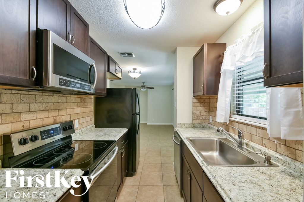 a kitchen with stainless steel appliances and granite counter tops