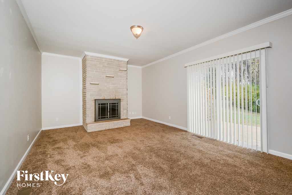 a living room with a fireplace and a large window