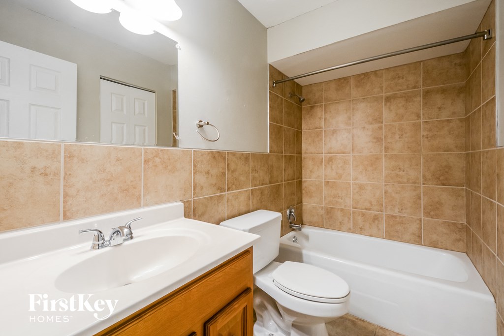 a full view of a bathroom with a sink toilet and tub