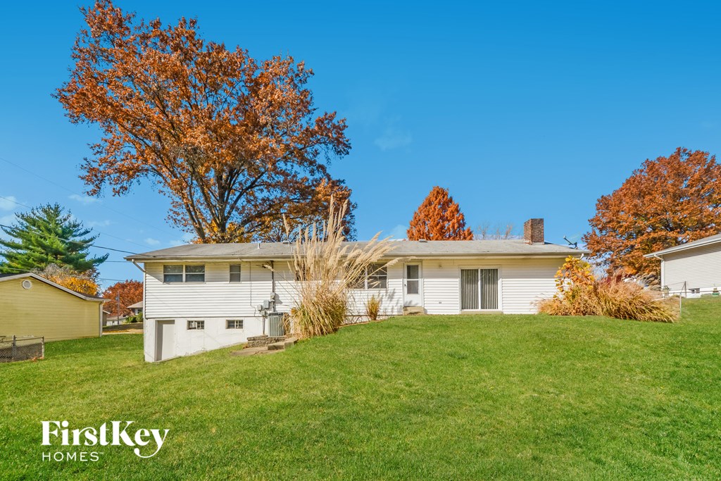 a white house on top of a grass covered hill