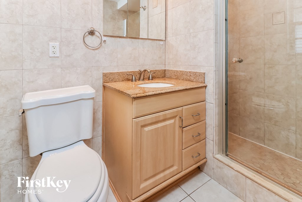 a bathroom with a toilet and a sink and a shower