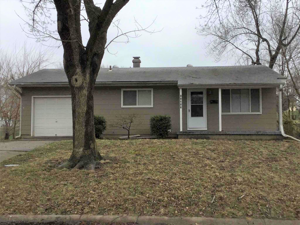 A house with a tree in front of it.