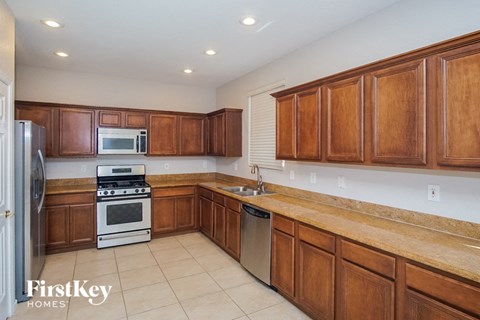 a kitchen with wooden cabinets and stainless steel appliances