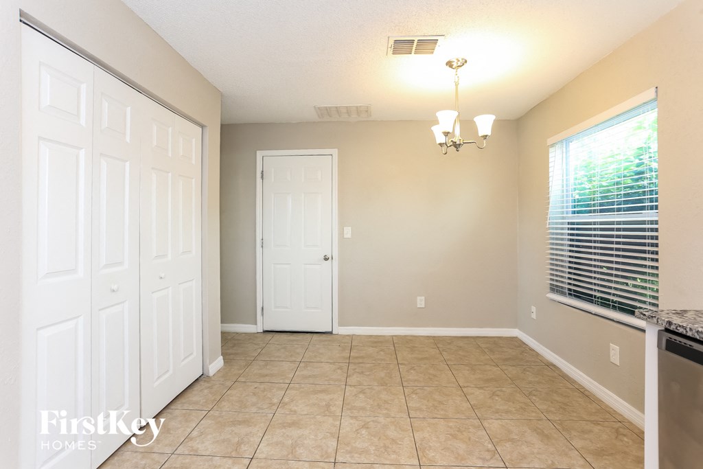 a kitchen with a large window and a tiled floor