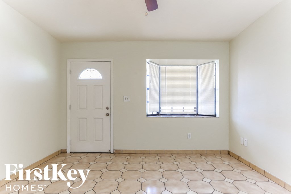 a empty room with a white door and a window