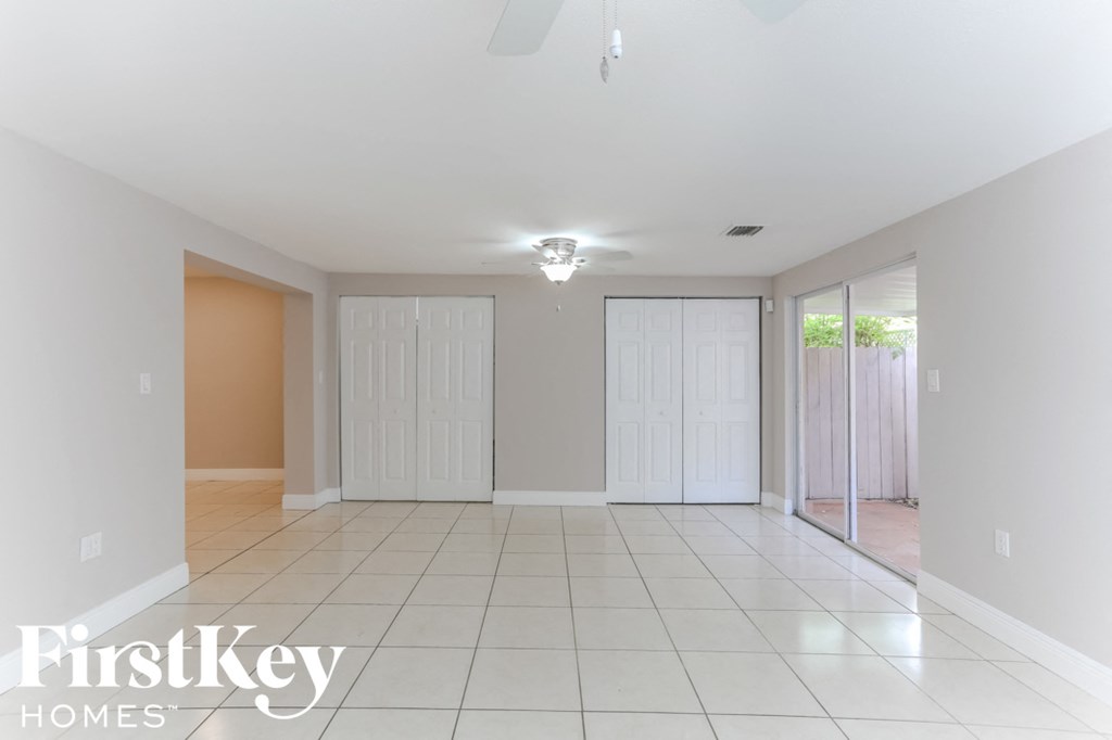 a empty living room with two closets and a tile floor