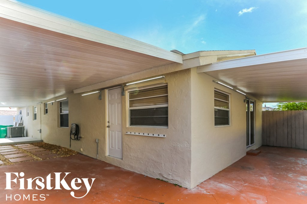 a home with a patio and a white house
