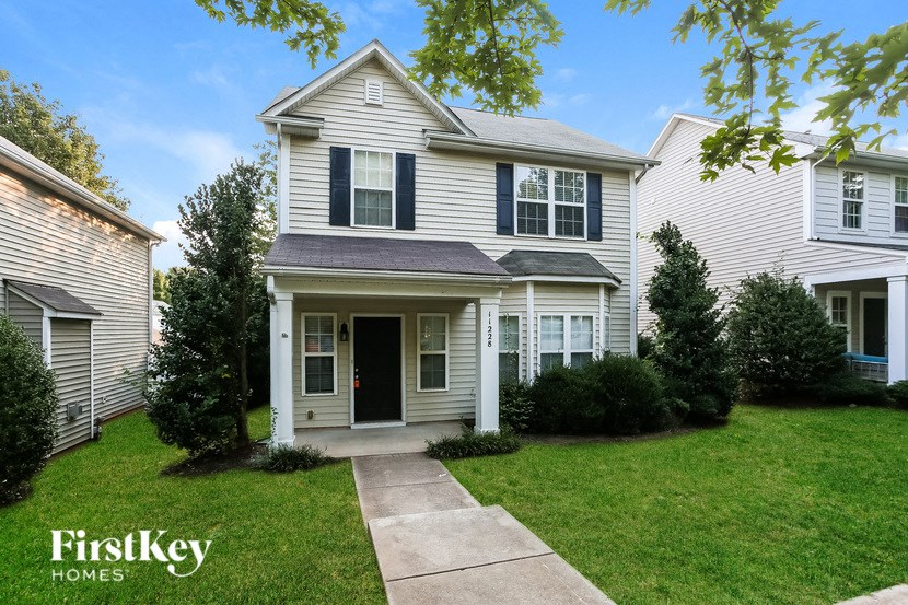 a white house with a sidewalk in front of it