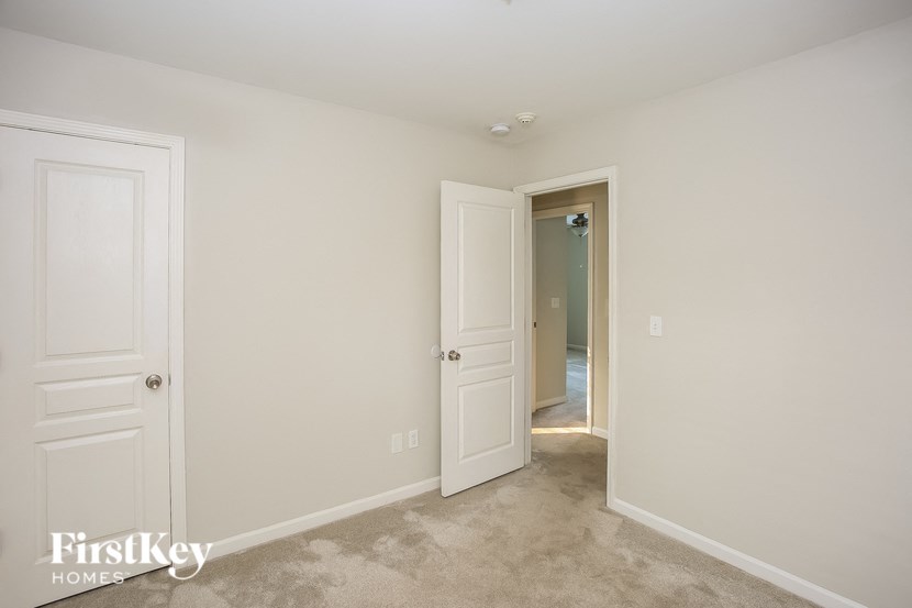 a bedroom with two closets and a door to a hallway