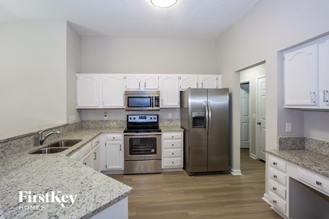 a kitchen with granite counter tops and stainless steel appliances