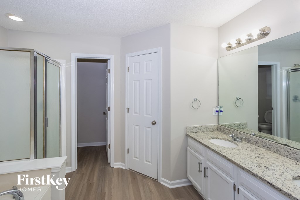 a bathroom with a sink and a mirror and a shower