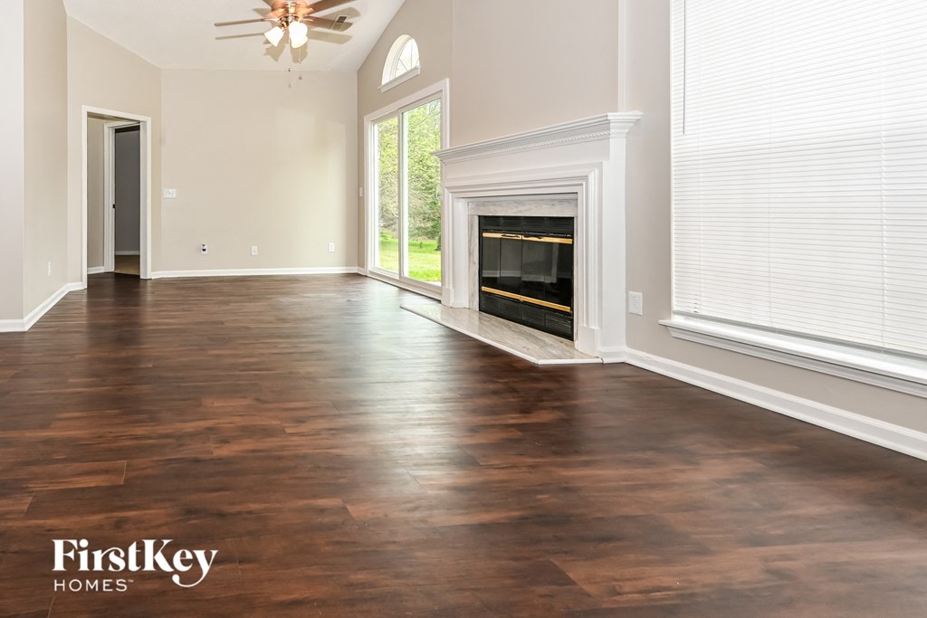 a living room with wood floors and a fireplace