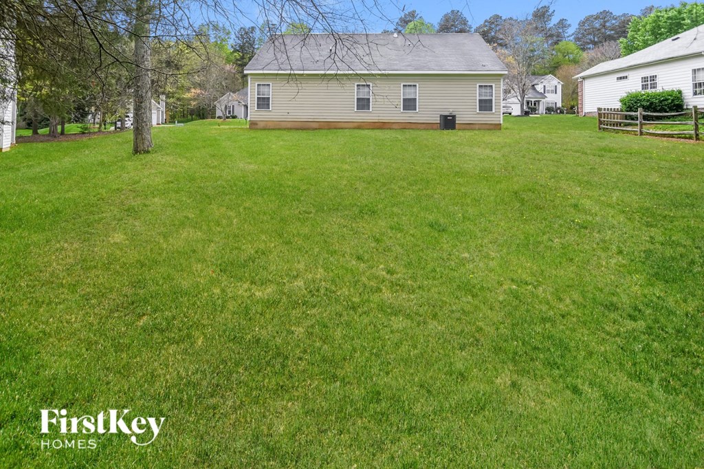 a backyard with a house and a yard with grass