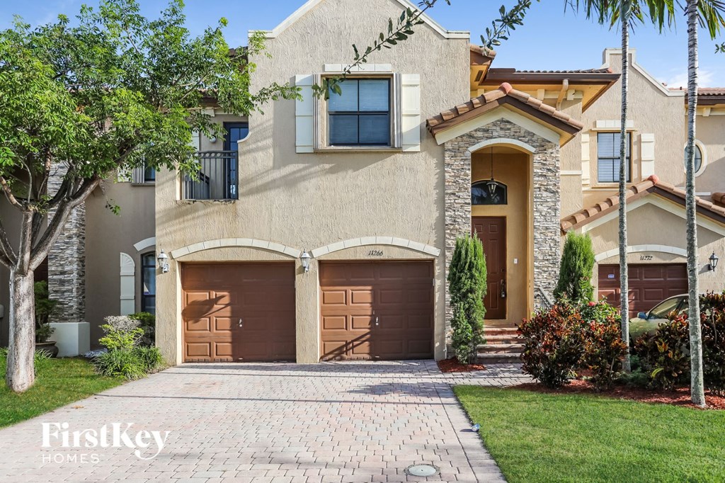 A house with a brown garage door is for sale.