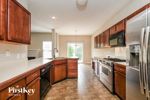 A kitchen with wooden cabinets and stainless steel appliances.