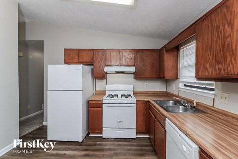 a kitchen with white appliances and wooden cabinets