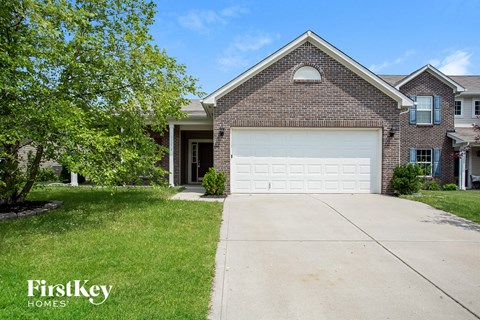 A house with a garage door is for sale by FirstKey Homes.