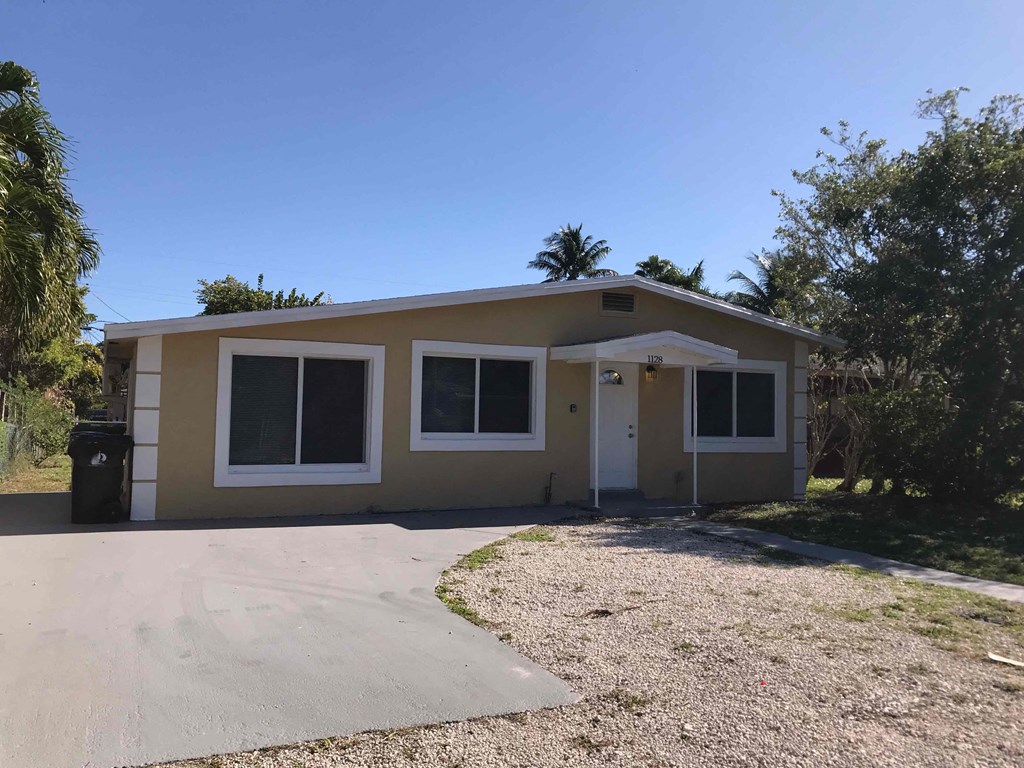 A two-story house with a driveway in front.