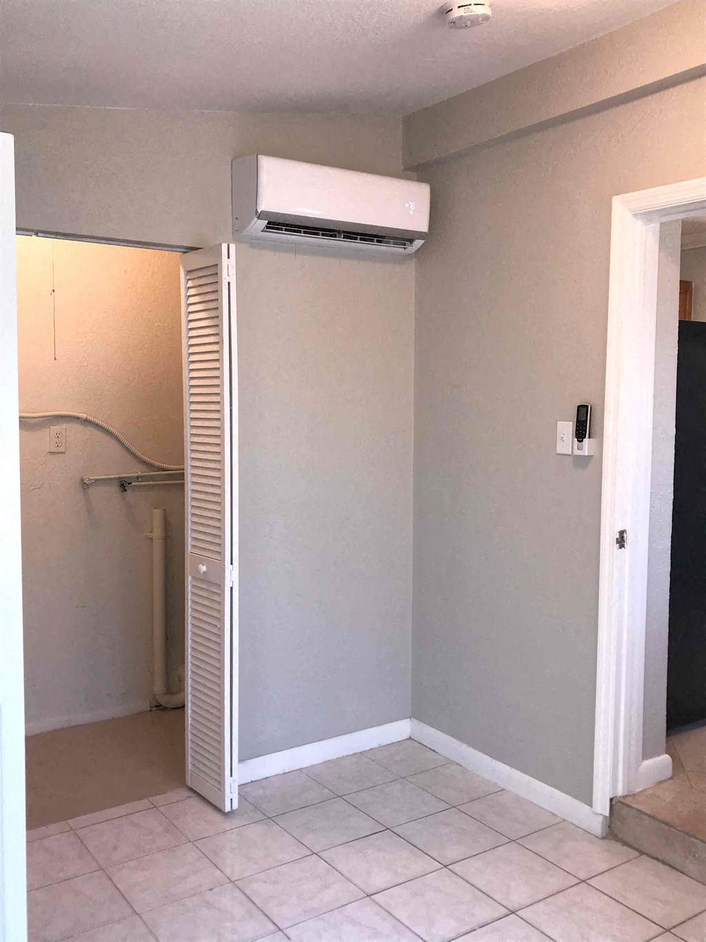 A wall-mounted air conditioner is installed in a room.