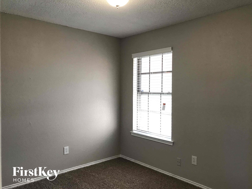 the living room of an empty house with a window