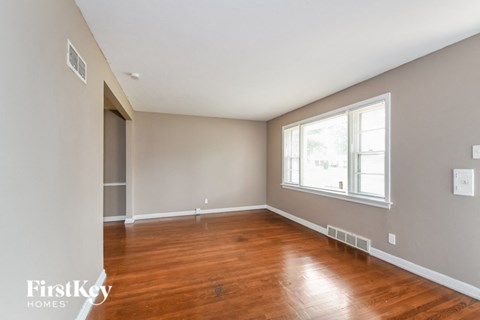 a living room with wood floors and a large window