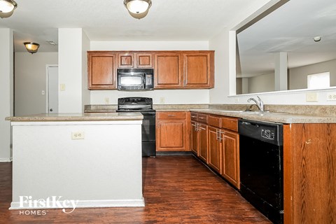 A kitchen with wooden cabinets and a white island.