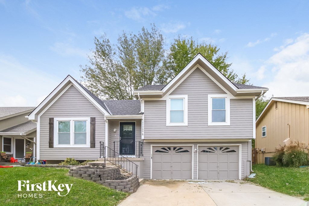 a gray house with a garage and a driveway