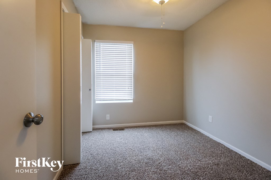 a empty room with a door and a window