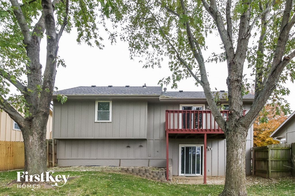 the exterior of a house with two trees in front of it