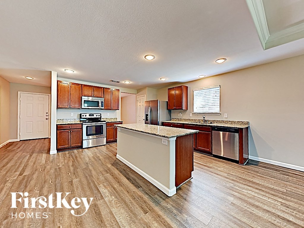 A kitchen with wooden cabinets and a white island.