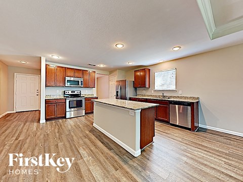 A kitchen with wooden cabinets and a white island.