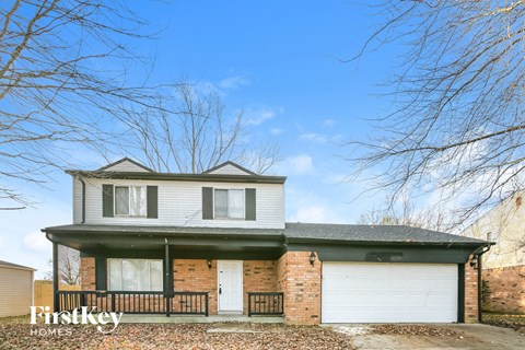 A two-story house with a garage is for sale.