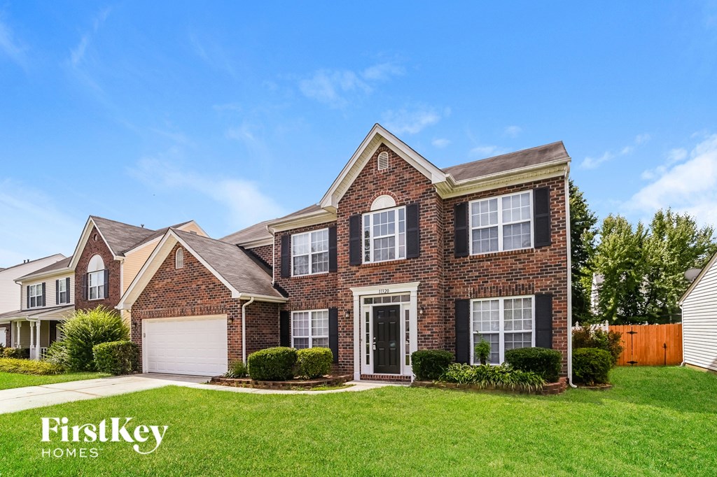 a brick house with a lawn in front of it