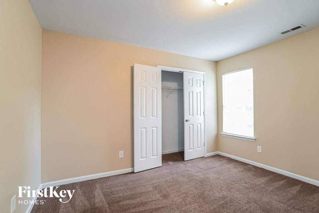 a bedroom with two doors and a door to a closet