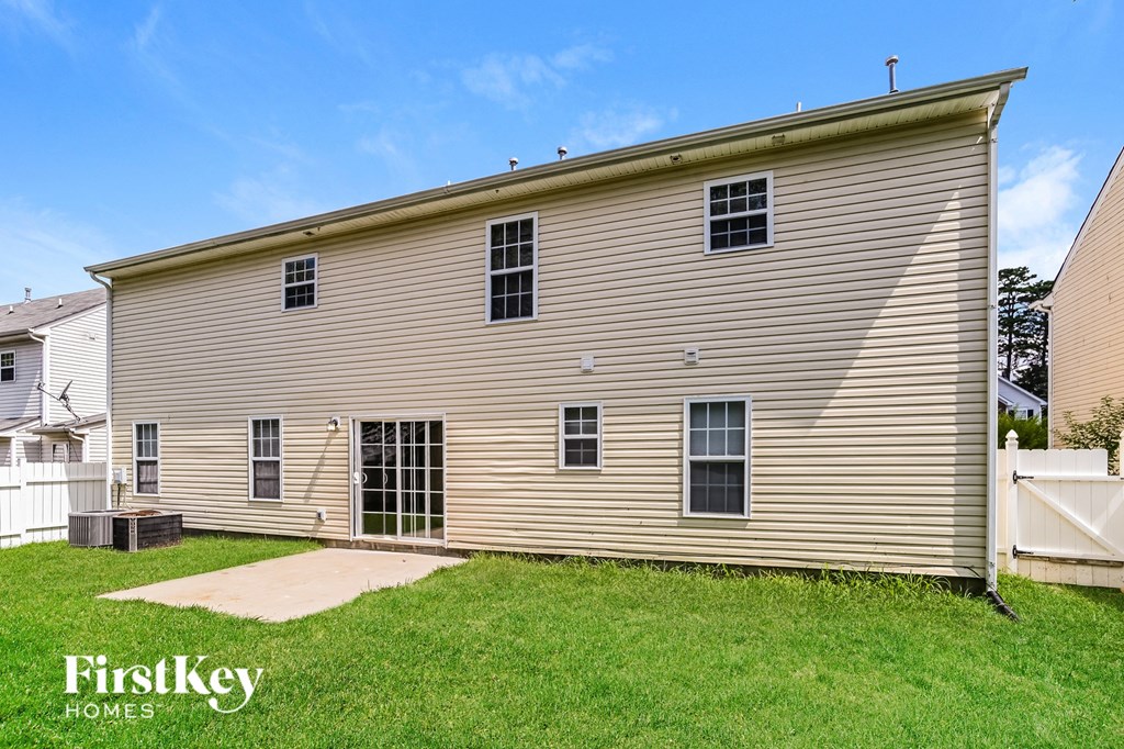 the outside of a house with a lawn and a driveway