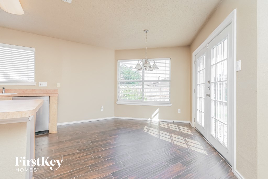 a kitchen and living room with wood floors and a window