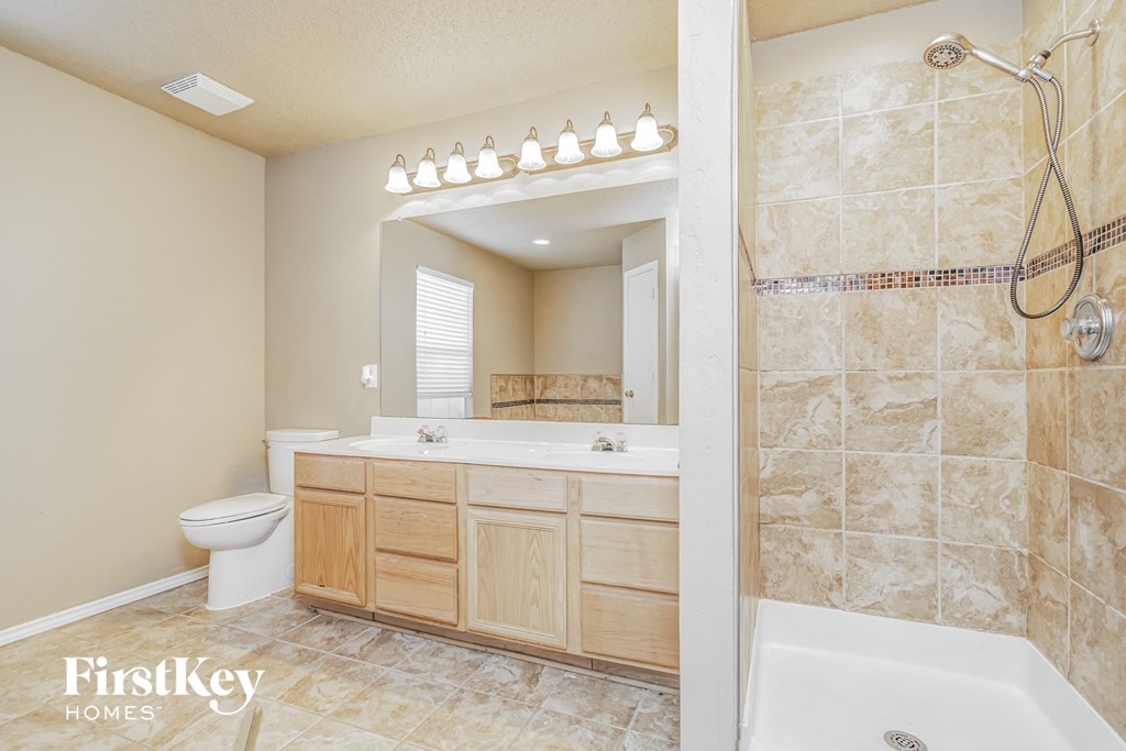 a bathroom with a shower toilet and sink and a bath tub