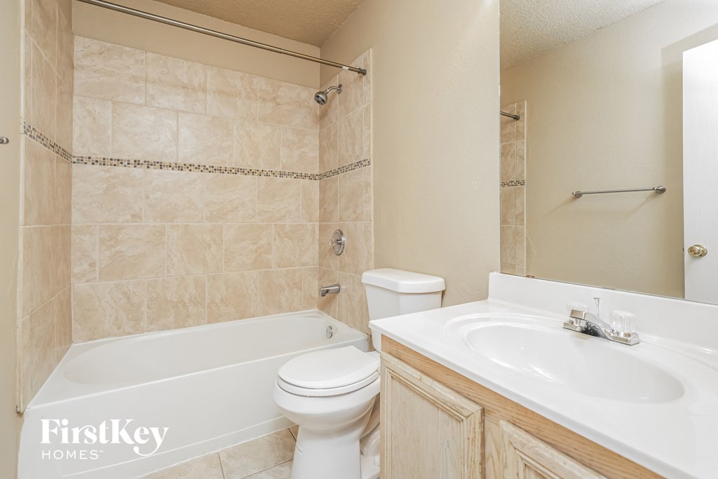 a bathroom with a sink toilet and a tub
