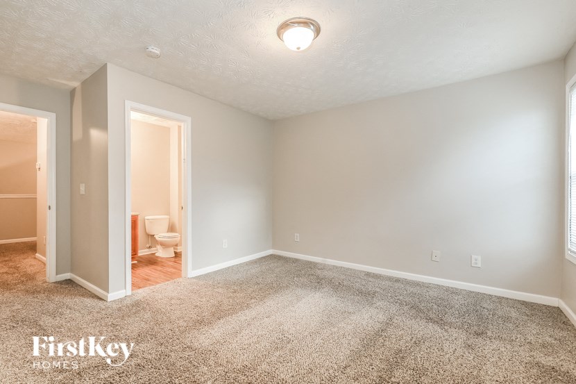 a room with carpet and a toilet in it