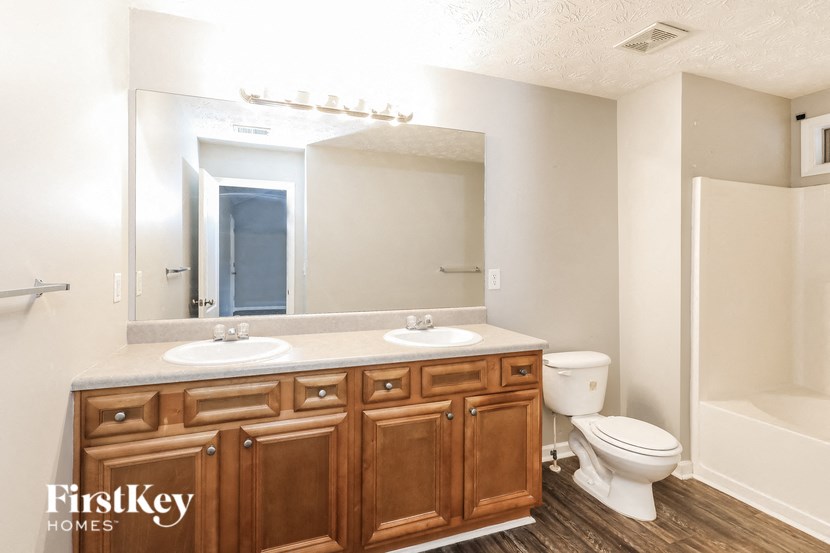 a bathroom with a toilet sink and a mirror