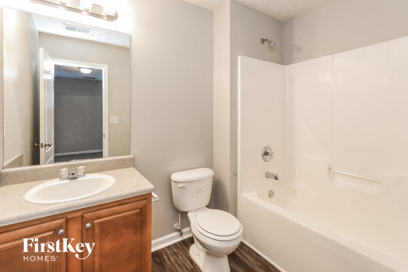 a bathroom with a sink toilet and a bath tub