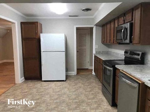 a kitchen with a white refrigerator and a stove