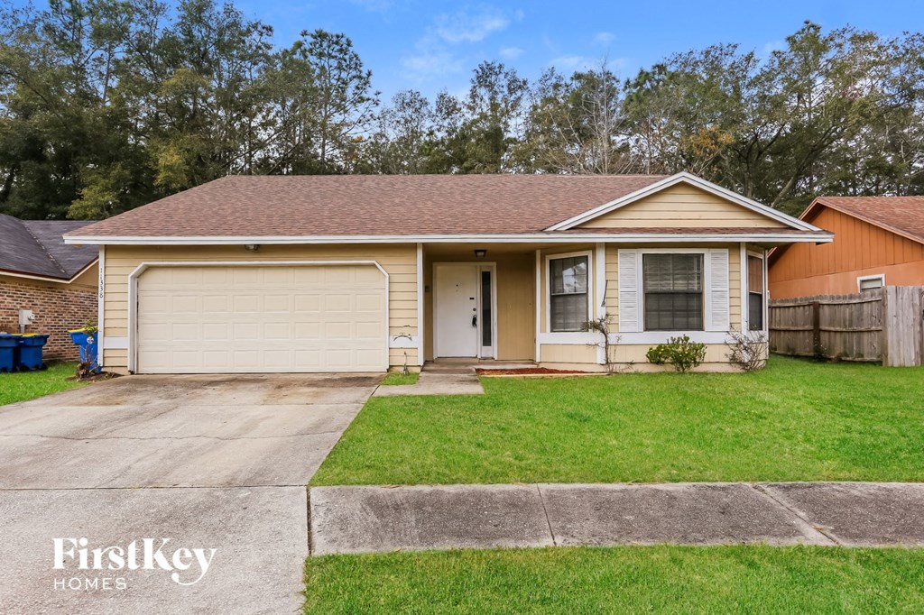 a home with a lawn and a driveway