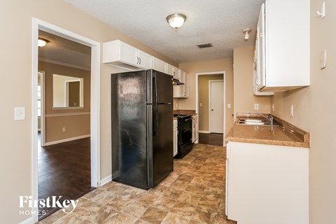 a kitchen with a stainless steel refrigerator and a sink