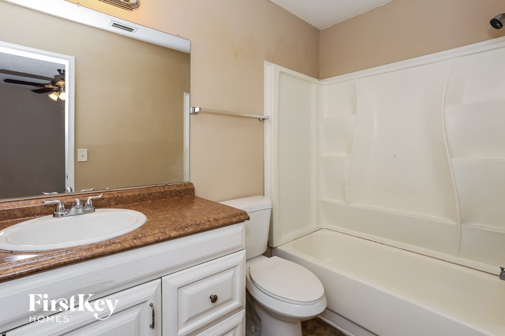 a bathroom with a sink toilet and a bath tub
