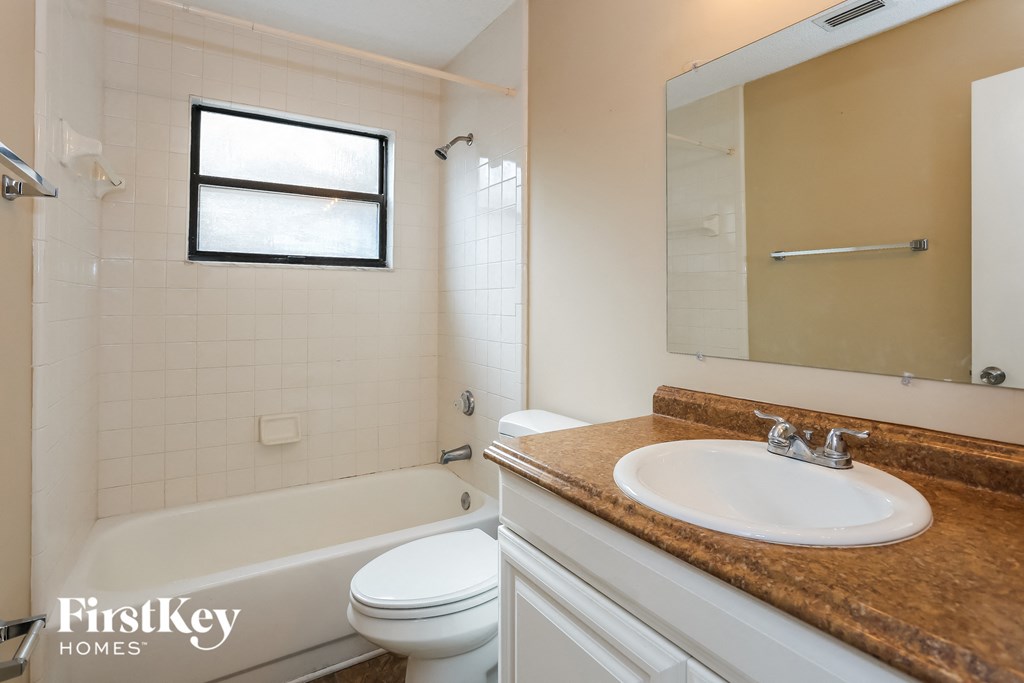 a bathroom with a sink and a toilet and a bath tub