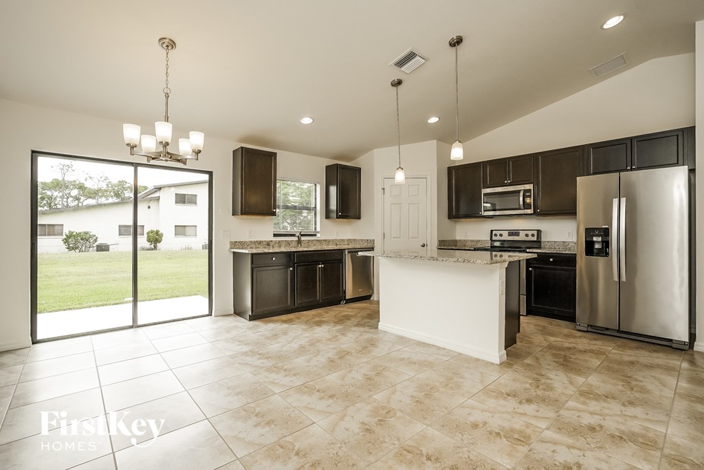 a kitchen with stainless steel appliances and a marble counter top