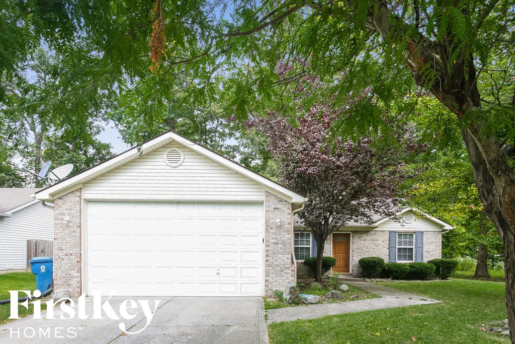 a white garage door in front of a white house