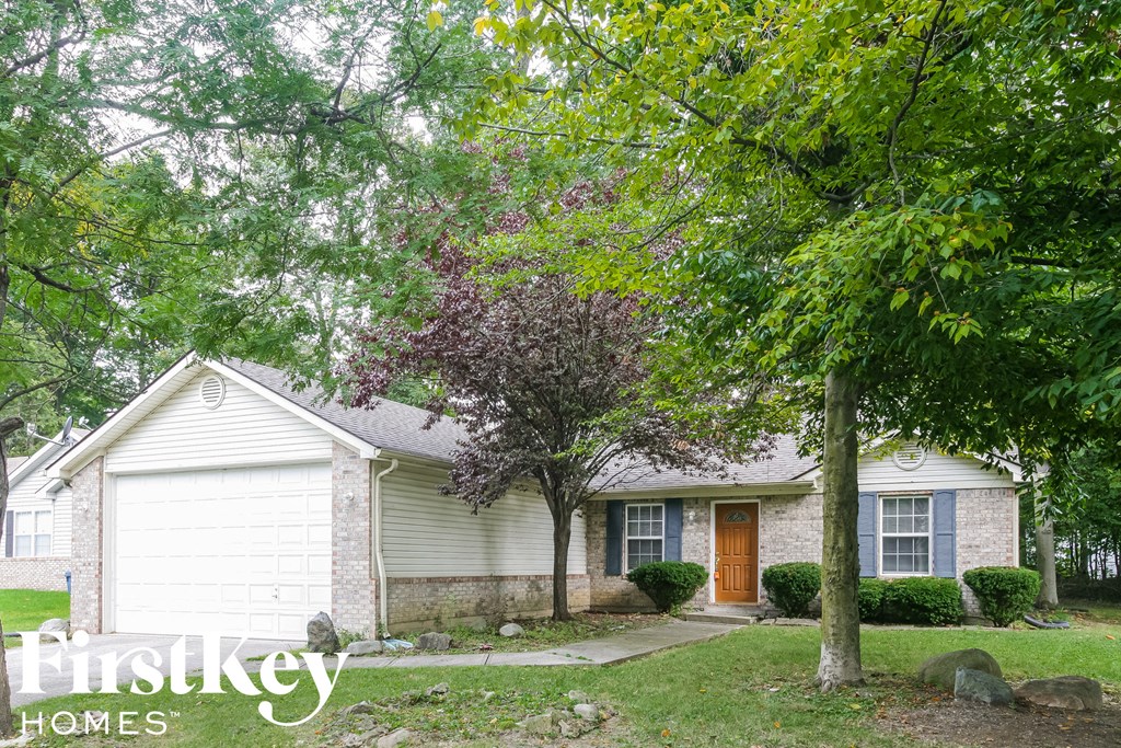 a small white house with trees in front of it