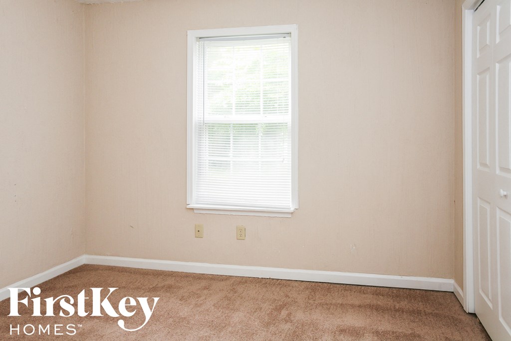 a room with carpet and a window in it